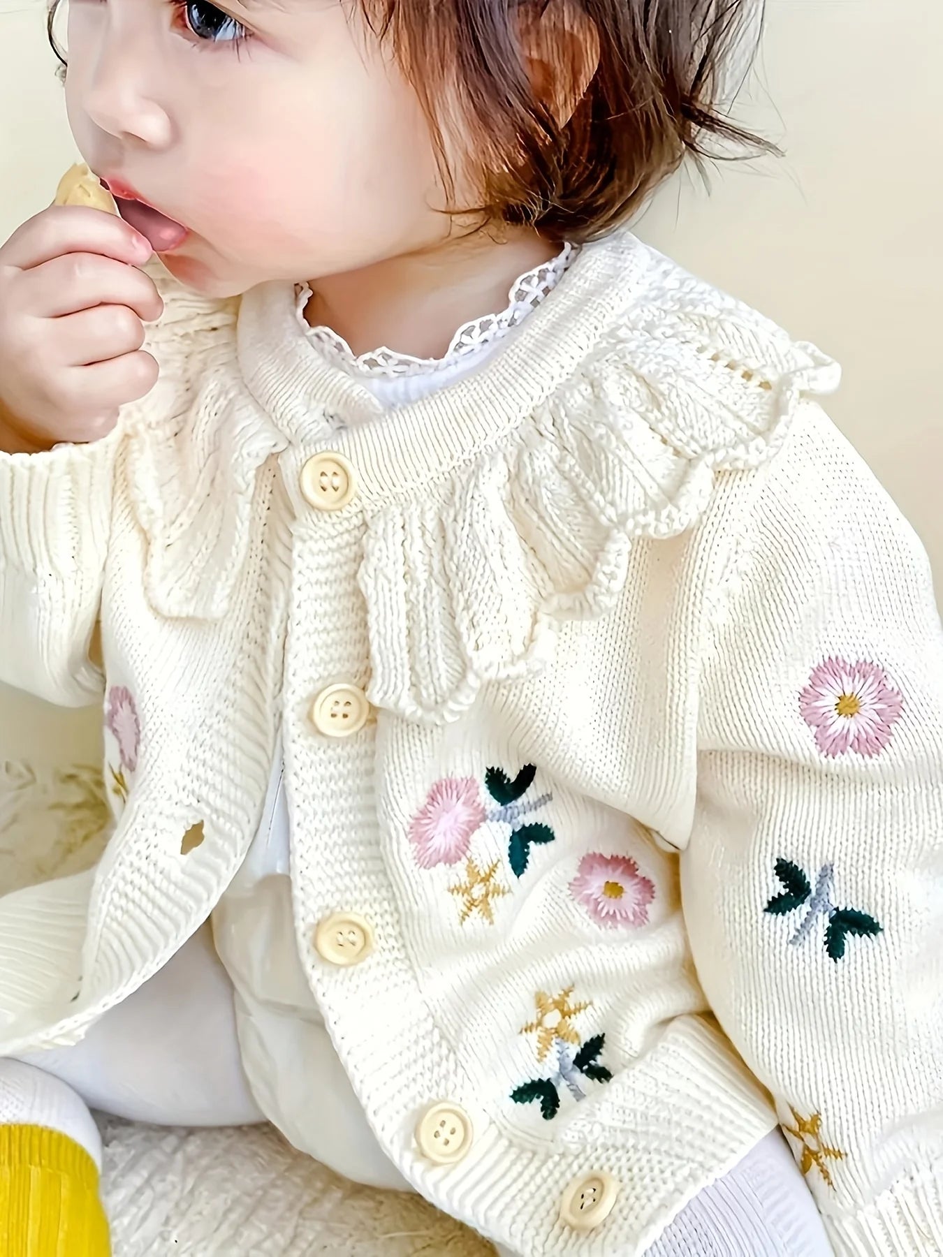Baby girl wearing floral knit cardigan sweater