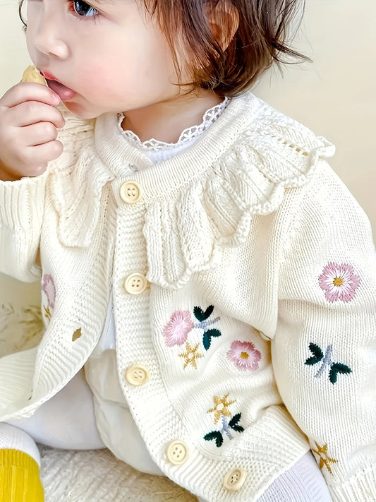 Baby girl wearing floral knit cardigan sweater