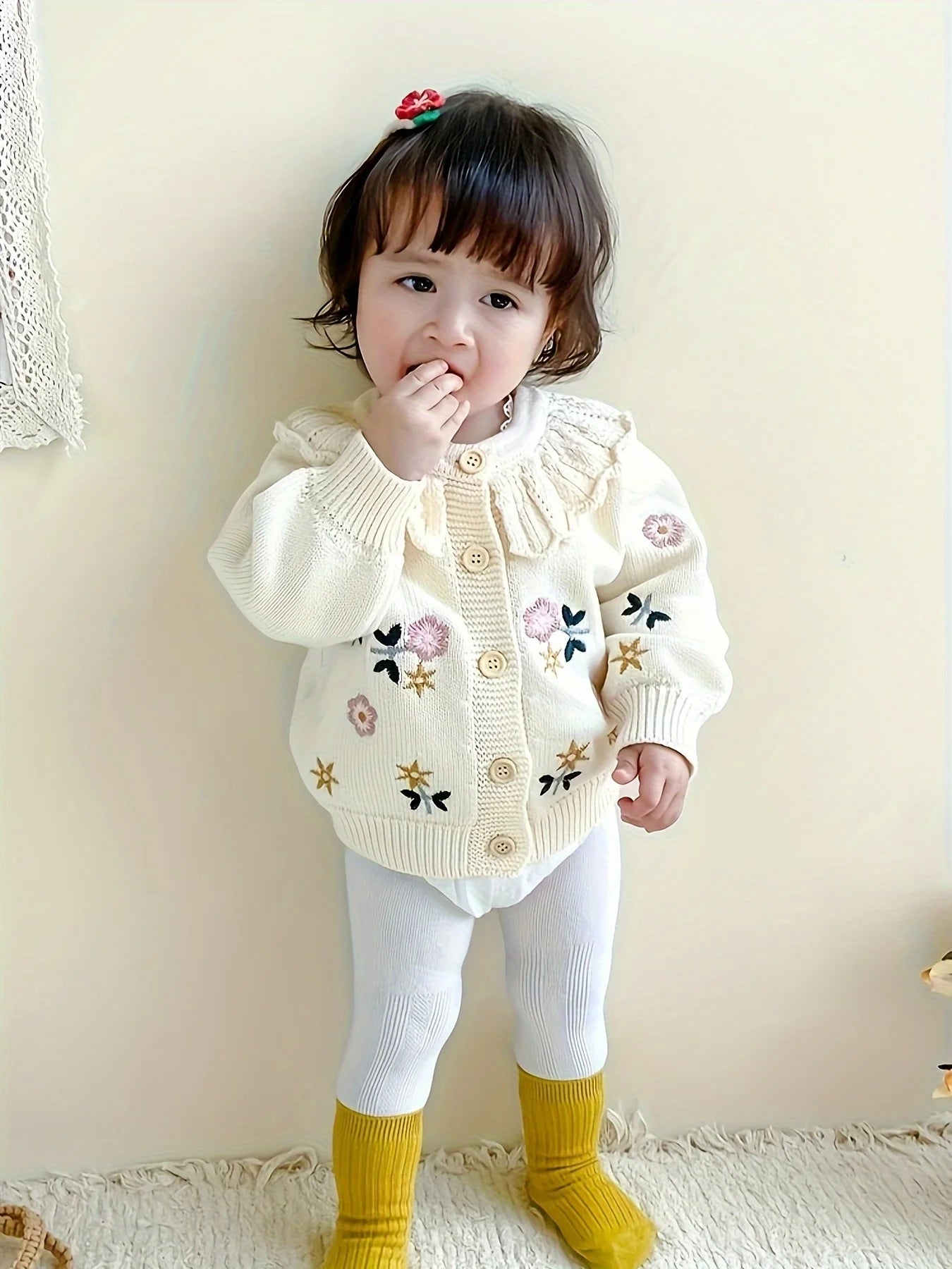Baby girl wearing floral knit cardigan sweater