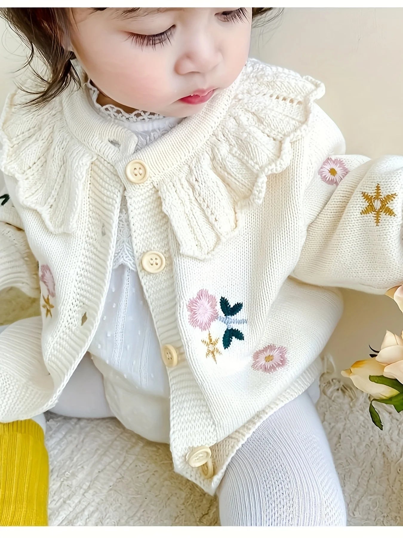 Baby girl wearing floral knit cardigan sweater